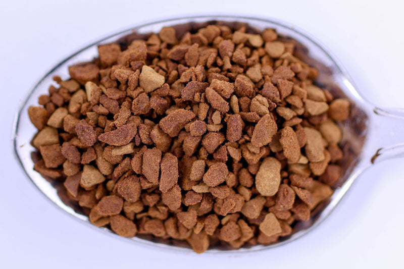 Close-up of freeze-dried instant coffee crystals on a spoon